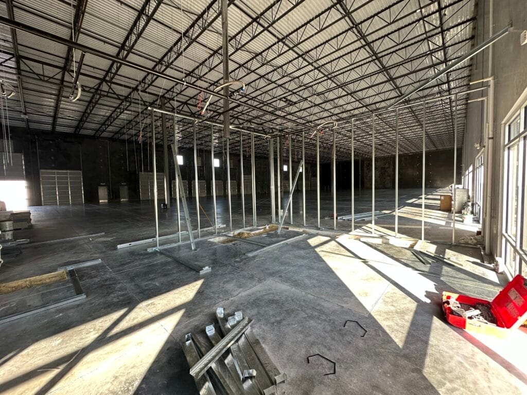 Empty warehouse shell with metal stud framing for spec offices