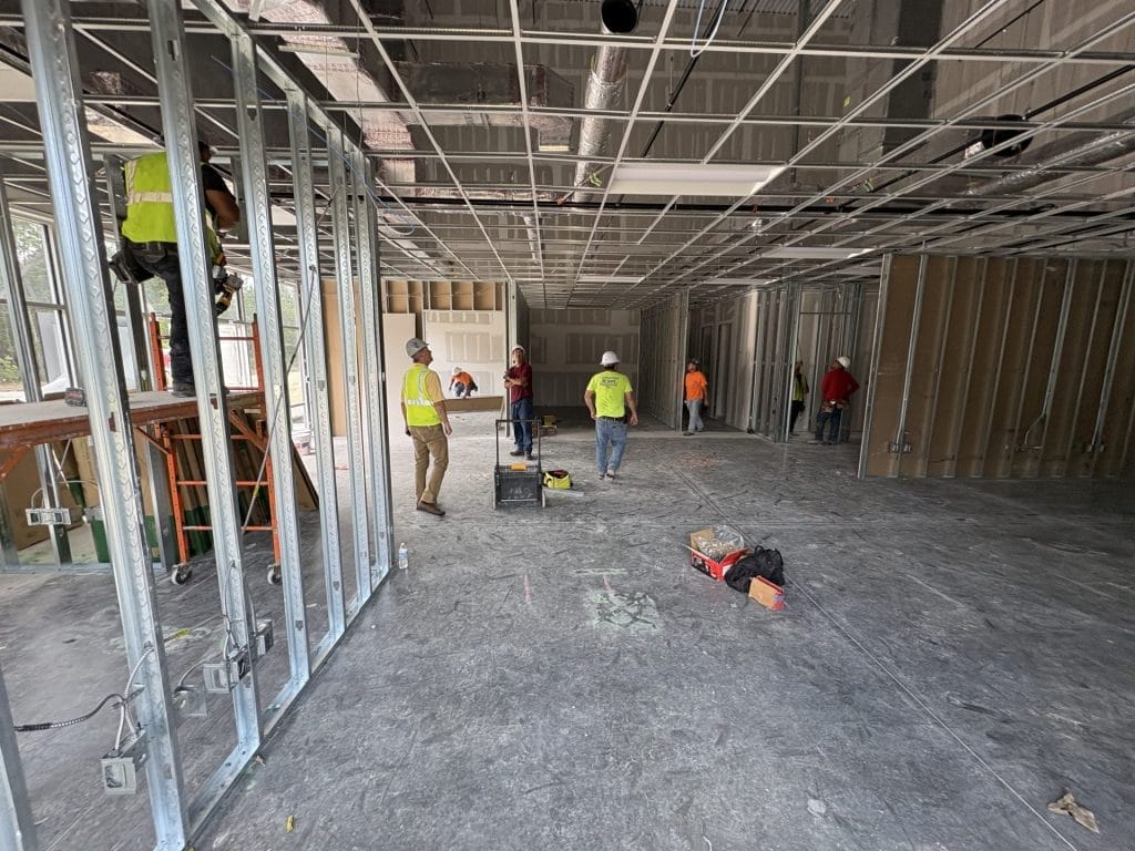 warehouse interior contractor Jacksonville - Spacious warehouse interior with high ceilings and industrial lighting, showcasi